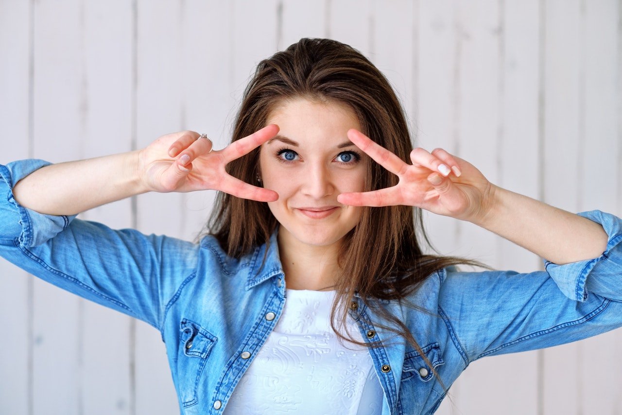 Woman posing with hand in front of eyes