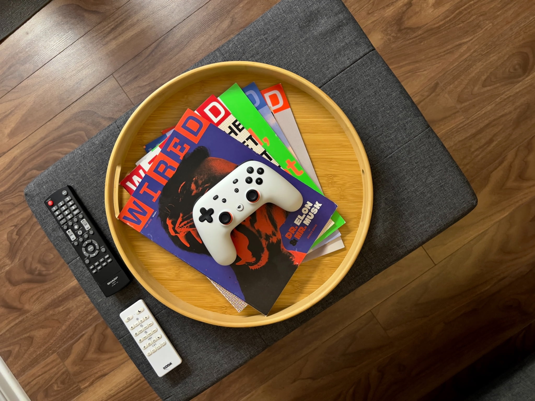 collection of gaming magazine under white controller